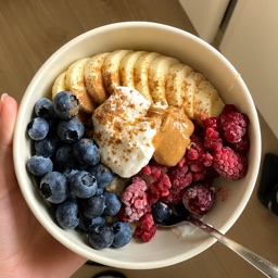 Fruit and yogurt bowl with berries, banana and peanut butter
